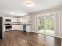 Well-lit eat-in kitchen featuring white cabinets, stainless steel appliances, and sliding glass doors to a patio at 3129 Thrasher Cir, Decatur, GA 30032