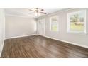Bright living room with hardwood floors, neutral walls, white trim, and natural light from large windows at 3129 Thrasher Cir, Decatur, GA 30032