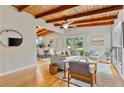 Inviting living room boasts hardwood floors, exposed wood beams, and natural light, seamlessly flowing into the dining area at 3185 Laventure Dr, Chamblee, GA 30341