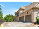 Spacious three-car garage with a large driveway at 5330 Cole Creek Ln, Cumming, GA 30040