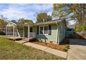 Charming light green home with a welcoming front porch and well-manicured lawn, perfect for curb appeal at 1019 Magbee Se Dr, Smyrna, GA 30080