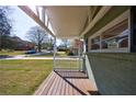 Inviting covered porch with classic white railings, providing a perfect spot for relaxing outdoors at 1019 Magbee Se Dr, Smyrna, GA 30080