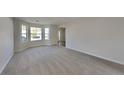 Spacious living room with large windows, providing ample natural light and great curb appeal at 4688 Snap Creek Ln, Decatur, GA 30035