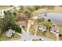Aerial view of homes with mature trees, a serene pond, and lush landscaping at 1340 Summer Lake Ter, Loganville, GA 30052