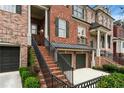 Brick townhome featuring a private entrance with a covered porch and well-kept landscaping at 1453 Montclair Se Ct # 26, Smyrna, GA 30080