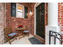 Cozy front porch featuring comfortable seating and charming brick detailing at 1453 Montclair Se Ct # 26, Smyrna, GA 30080