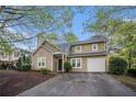 Charming two-story home featuring a front-entry garage and well-maintained landscaping at 1946 Glenwood Downs Dr, Decatur, GA 30035