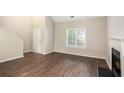 An inviting living room featuring high ceilings, hardwood floors and a cozy fireplace at 1946 Glenwood Downs Dr, Decatur, GA 30035