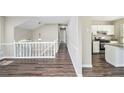 Open-concept living area with hardwood floors seamlessly connects to the kitchen, ideal for entertaining and gatherings at 3380 Saddleton Way, Douglasville, GA 30134