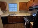 Well-lit kitchen featuring stainless steel appliances, granite countertops, and classic wood cabinetry at 3839 Henry Ct, Acworth, GA 30101