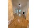 Bright open-concept living room featuring wood floors, crown molding, and a cozy fireplace at 5760 Old Carriage Dr, Atlanta, GA 30349