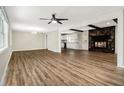 Spacious living room with wood floors, stone fireplace, and an open kitchen at , Decatur, GA 30035