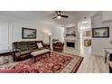 Spacious living room featuring a leather sofa, fireplace, and wood-look floors at 1213 Harris Commons Place, Roswell, GA 30076