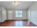 Bright living room with a large window, laminate floors, and fresh paint at 167 Fairview Oak Trl, Dallas, GA 30157