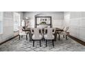 Elegant dining room with wainscoting, neutral color palette, modern rug, and seating for six at 3308 Pate Rd, Snellville, GA 30078
