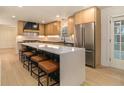 Modern kitchen featuring a large island with seating, stainless steel appliances, and light wood cabinetry at 1122 Manning Farms Ct, Atlanta, GA 30338