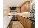 Updated kitchen with stainless steel appliances, granite counters, a white tile backsplash, and light wood cabinets at 1122 Manning Farms Ct, Atlanta, GA 30338