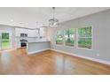 Well-lit dining area with view of the modern kitchen and backyard at 1857 Derrill Dr, Decatur, GA 30032