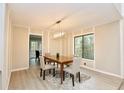 Bright dining room with modern lighting and stylish wood-look flooring with large window views at 4579 Glenforest Ne Dr, Roswell, GA 30075