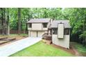 Charming home boasts a two-car garage and beautifully landscaped front yard with mature trees at 4579 Glenforest Ne Dr, Roswell, GA 30075