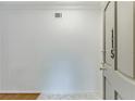 Bright foyer featuring stylish floor tiles, fresh white walls, and a partial view of the wooden door at 115 Woodmere Nw Sq # 115, Atlanta, GA 30327