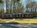 Brick ranch home boasts a lush front yard, enhancing its curb appeal at 4063 Windsor Castle Way, Decatur, GA 30034