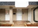 Close up showing a brick facade and the front door entrance to this townhome at 5210 Chemin De Vie, Atlanta, GA 30342