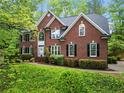 Traditional two-story brick home featuring a manicured lawn and symmetrical design at 5729 Brookstone Nw Walk, Acworth, GA 30101
