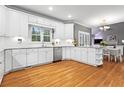 Bright kitchen boasts white cabinetry, granite countertops, and stainless steel appliances at 5729 Brookstone Nw Walk, Acworth, GA 30101