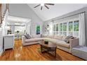 Open living room with hardwood floors, vaulted ceiling, and large windows offering an abundance of natural light at 5729 Brookstone Nw Walk, Acworth, GA 30101