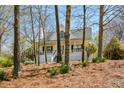 Charming home featuring a covered front porch and a beautifully landscaped front yard with mature trees at 507 Anthony Pl, Canton, GA 30114
