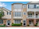 Attractive townhome showcasing detailed architectural features, light-colored facade, and well-maintained landscaping at 111 Riverstone Commons Cir, Canton, GA 30114