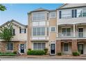 Lovely townhomes displaying unique front facades, manicured greenery, and welcoming entrances at 111 Riverstone Commons Cir, Canton, GA 30114