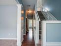 Bright foyer with hardwood floors, staircase, and neutral paint, creating a welcoming ambiance at 111 Riverstone Commons Cir, Canton, GA 30114