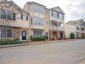 Street view of charming townhomes featuring diverse facades and neatly kept landscaping at 111 Riverstone Commons Cir, Canton, GA 30114