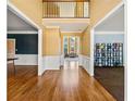 Bright foyer with hardwood floors, wainscoting, and views of the formal living area at 1460 Edgemont Pt, Lawrenceville, GA 30044