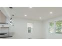 Bright living room area with modern light fixtures and lots of windows at 1956 Washington Rd, East Point, GA 30344