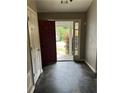 Inviting entryway with tile flooring, a red door, and natural light streaming in at 3415 Camens Ct, Buford, GA 30519
