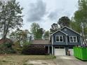 Charming two-story home with blue siding, white trim, and a well-manicured front yard at 3415 Camens Ct, Buford, GA 30519