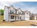 Beautiful two-story brick home featuring a covered front porch and attached two-car garage at 3681 Deaton Trl, Buford, GA 30519
