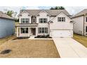 Charming brick home with a manicured lawn, covered porch, and a two-car garage, displaying appealing curb appeal at 3681 Deaton Trl, Buford, GA 30519