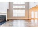 Bright living room with a fireplace, large windows, and wood flooring at 3681 Deaton Trl, Buford, GA 30519