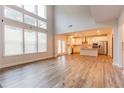 Spacious open-concept living area with hardwood floors and an adjacent kitchen at 3681 Deaton Trl, Buford, GA 30519