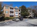 Multi-story condo building with balconies and well-maintained landscaping at 434 Bentley Place, Tucker, GA 30084