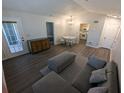 Cozy living room featuring hardwood floors, neutral paint, and access to the balcony at 434 Bentley Place, Tucker, GA 30084