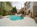 Inviting outdoor pool area with sun loungers and a lush, landscaped backyard at 4981 Millwood Dr, Canton, GA 30114