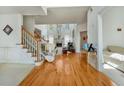 Grand foyer with hardwood floors, staircase, and open view to the living area at 2924 Meadow Church Rd, Suwanee, GA 30024