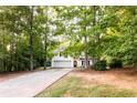 Traditional home with an elongated driveway and plenty of trees surrounding the property at 355 Freeman Dr, Covington, GA 30016