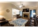 Inviting living room with a stone fireplace, ceiling fan, and beautiful leather seating at 355 Freeman Dr, Covington, GA 30016
