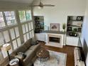 Bright and airy living room with large windows, fireplace, and hardwood floors at 4658 Glory Maple Trce, Powder Springs, GA 30127
